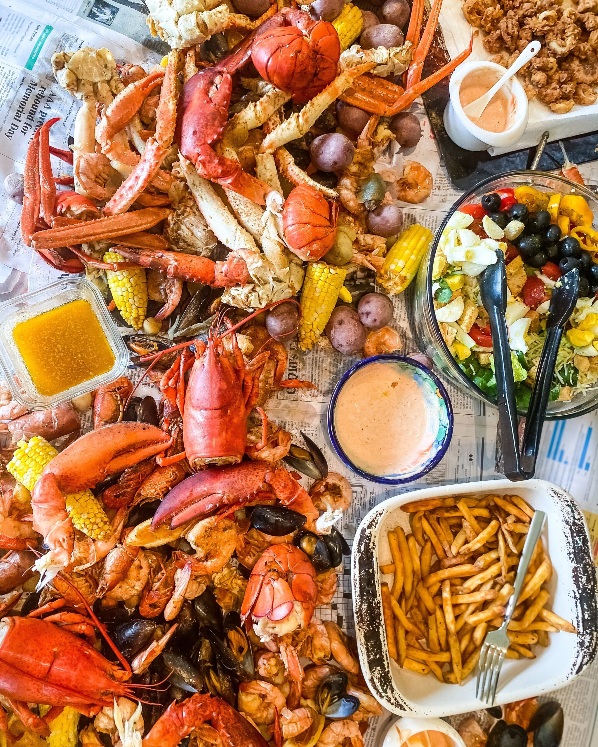 A vibrant seafood spread with dipping sauces and side dishes.