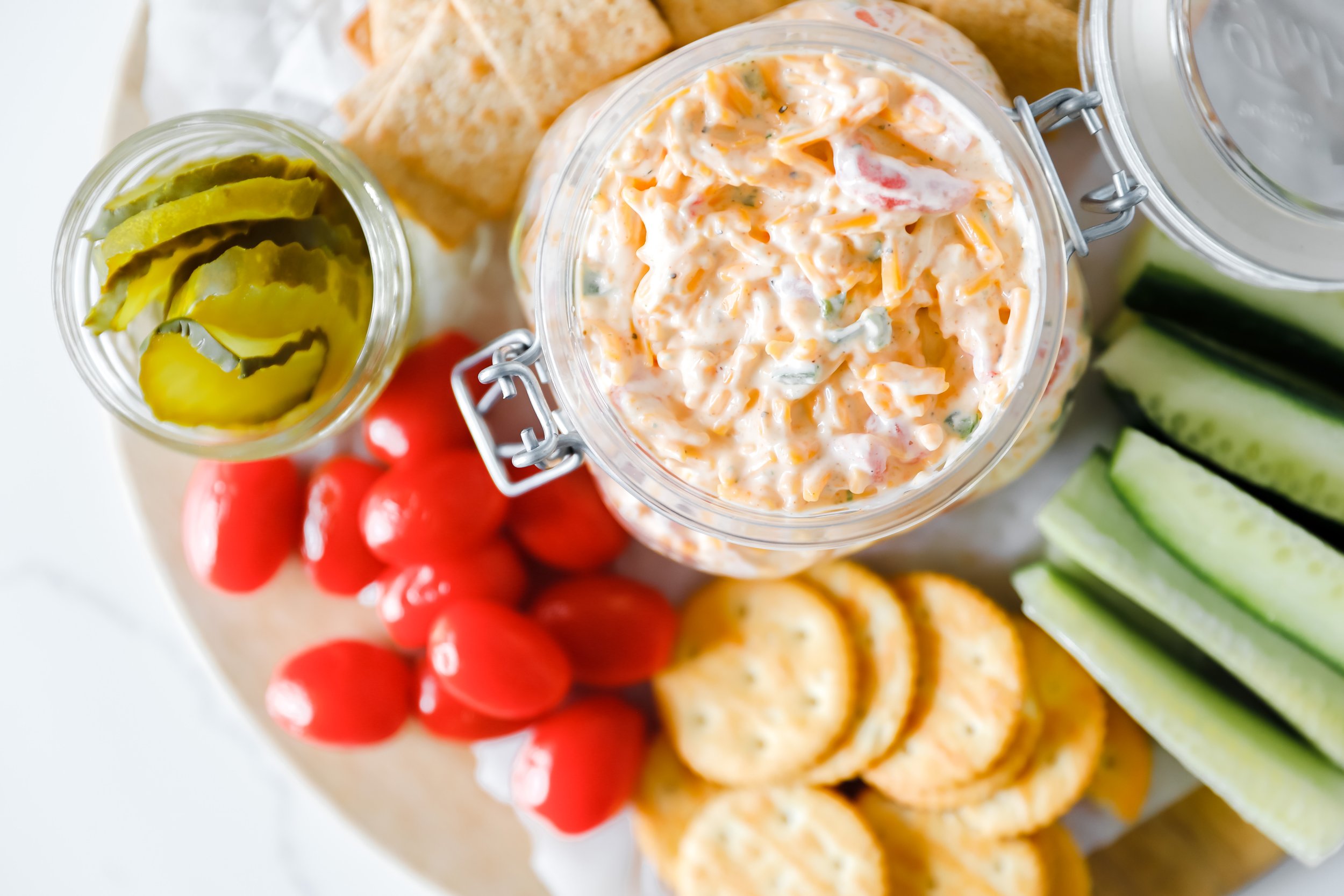 Homemade Southern pimento cheese spread served with crackers and vegetables.