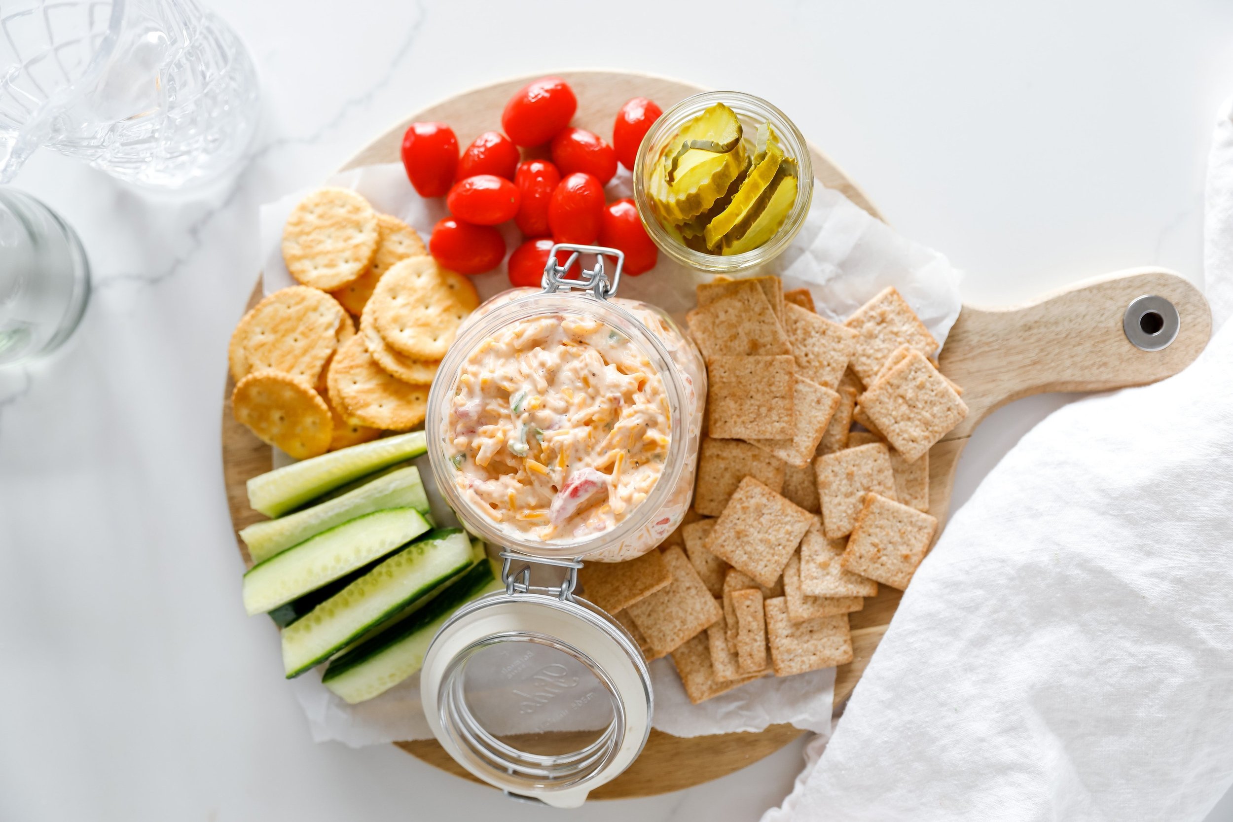 Homemade Southern pimento cheese spread served with crackers and vegetables.