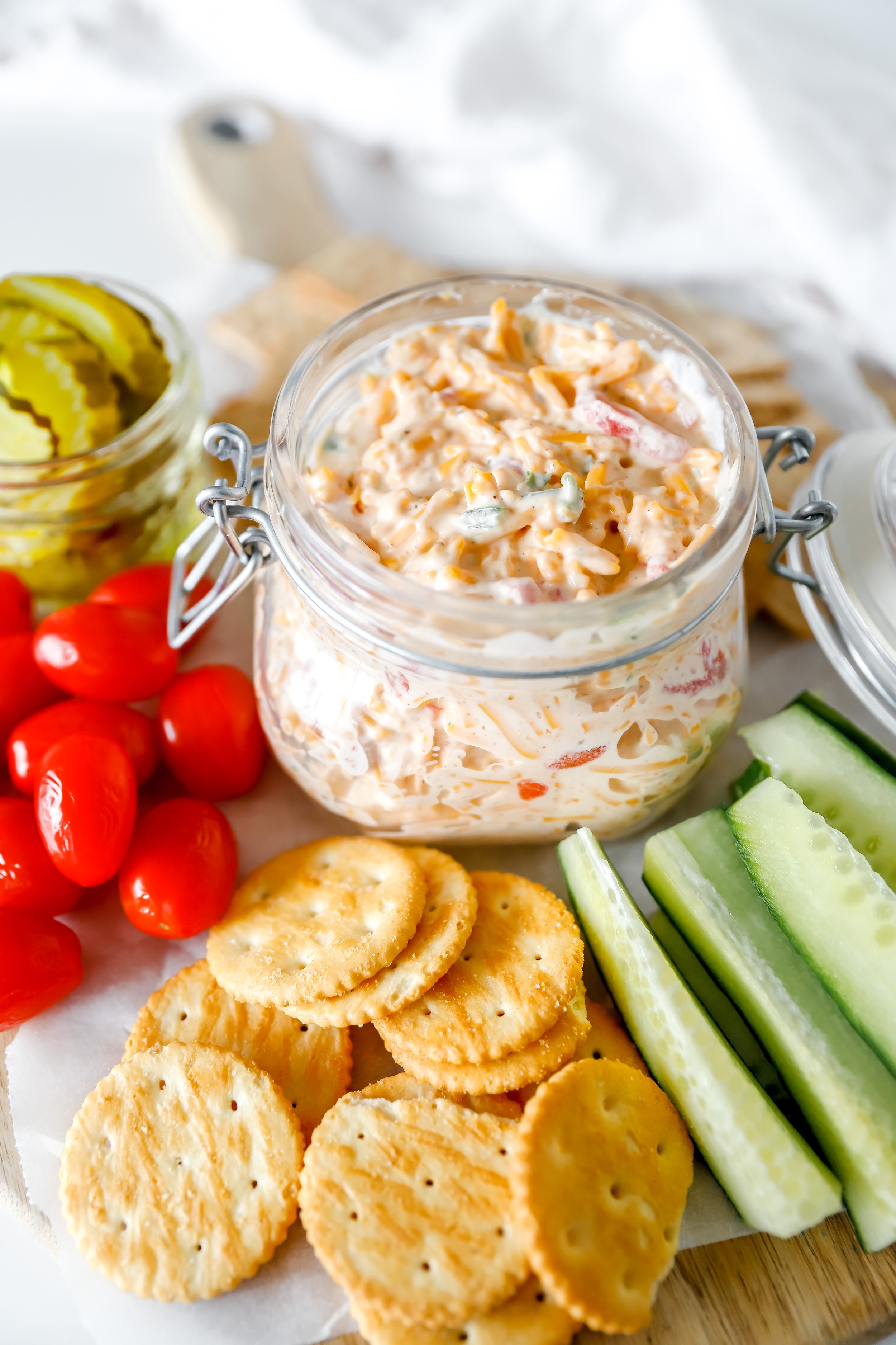 Close-up of creamy pimento cheese with shredded cheddar and diced pimentos.