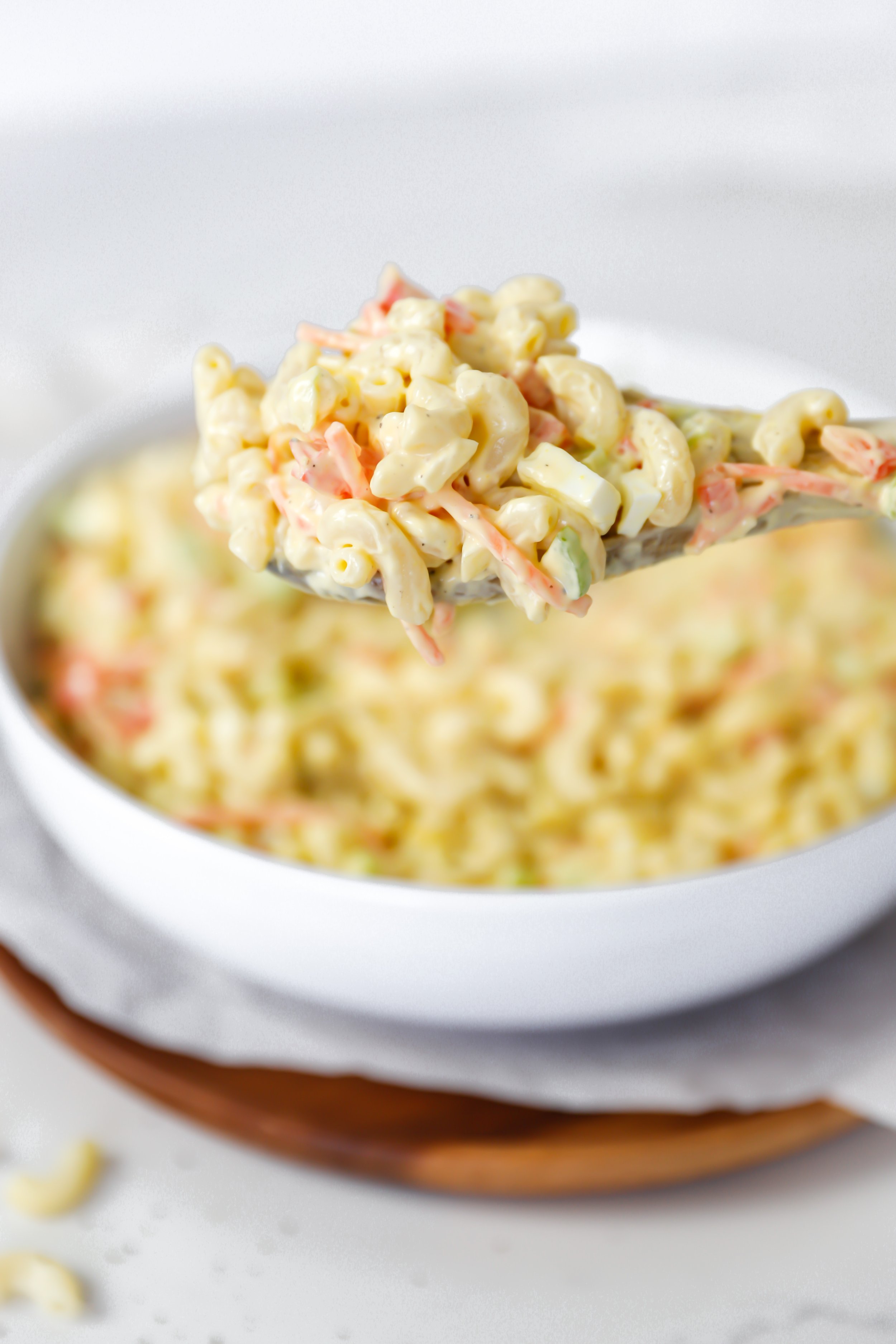 Classic macaroni salad with elbow macaroni, diced vegetables, and a creamy dressing, perfect for summer BBQs and gatherings.