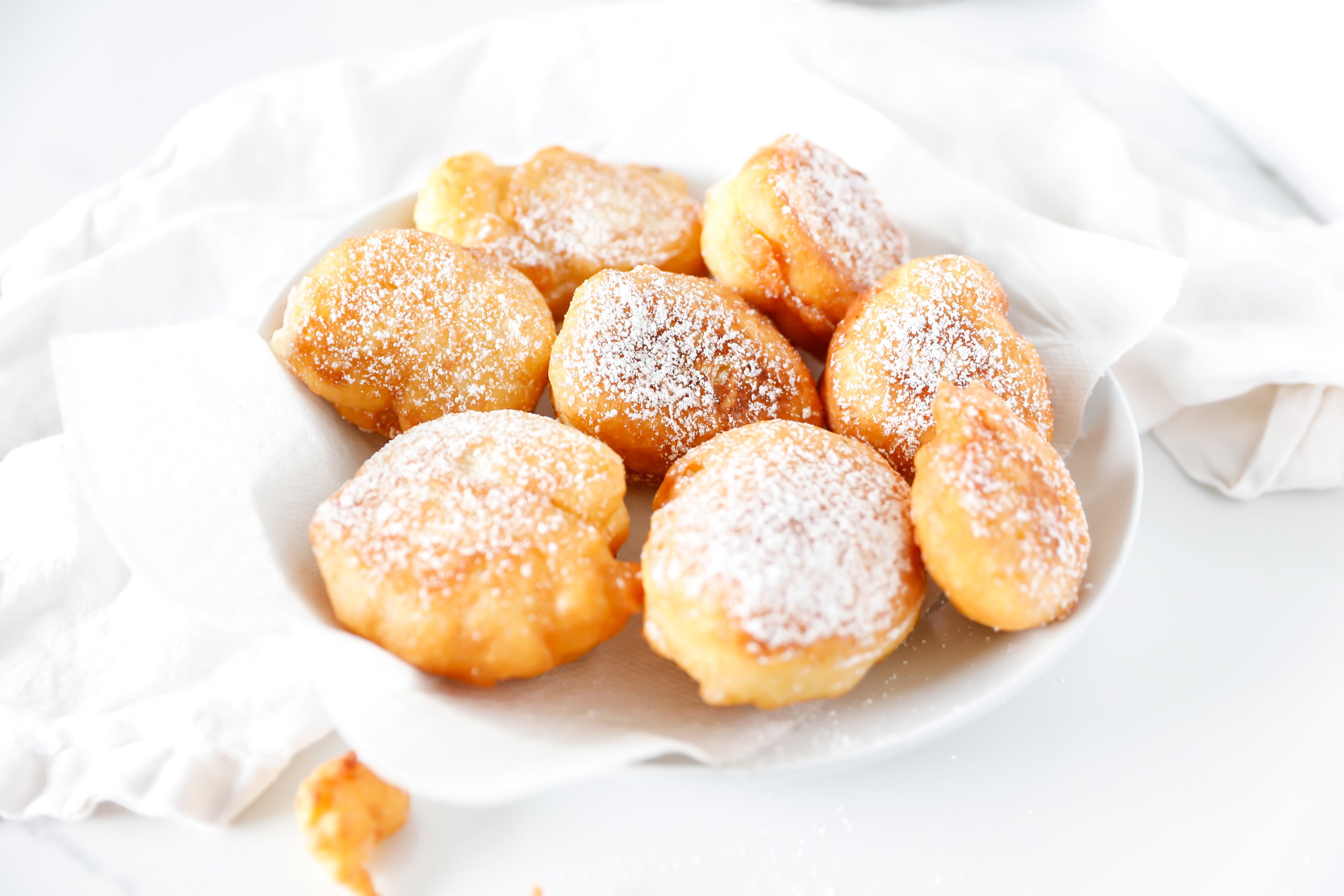 Close-up of crispy, golden Funnel Cake Donuts dusted with powdered sugar