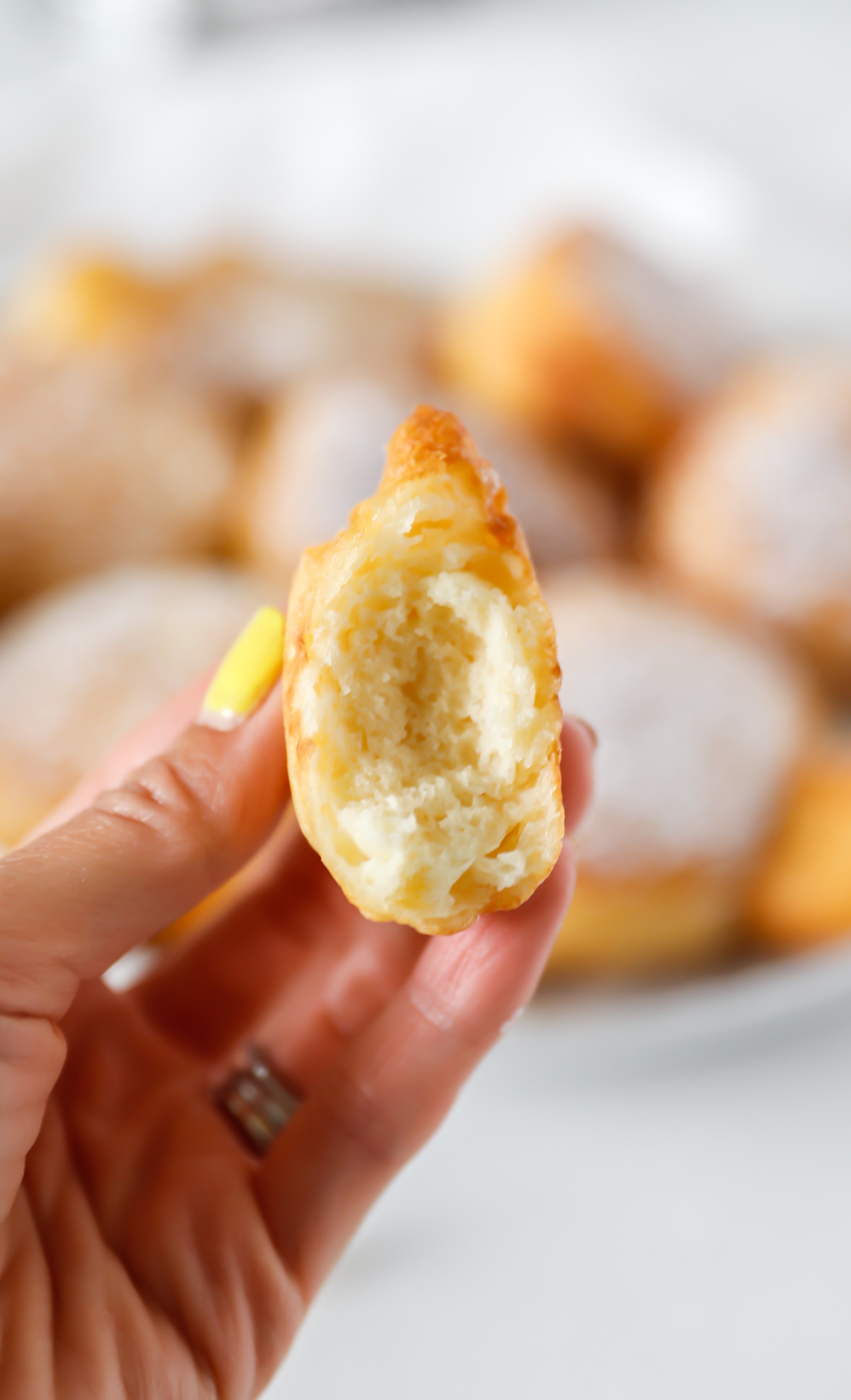 Close-up of crispy, golden Funnel Cake Donuts dusted with powdered sugar