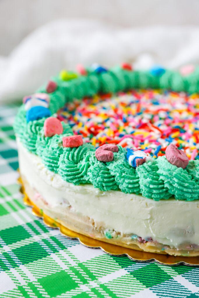 No bake Lucky Charms cheesecake with sugar cookie dough crust and festive St Patrick's Day toppings