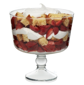 Footed trifle bowl with layered strawberry shortcake dessert.
